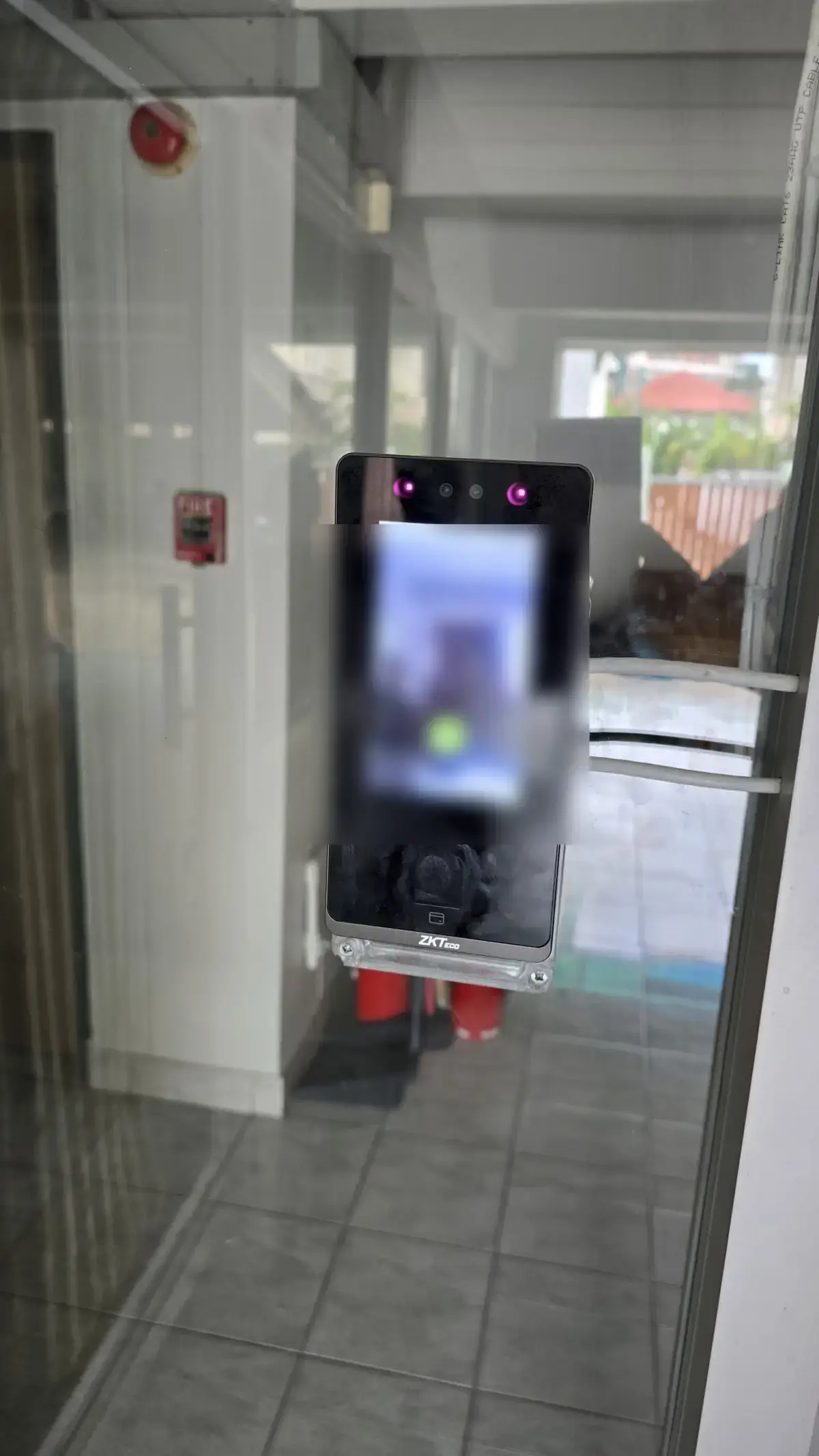 The face reader mounted on the glass entrance door